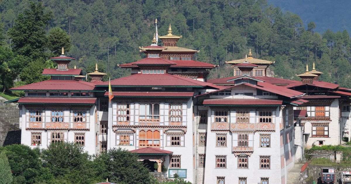 Mongar Dzong with its red roofs set against forested hills