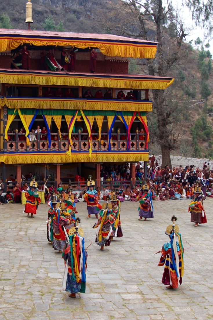 Masked dancers performing at Paro Tshechu in front of Rinpung Dzong